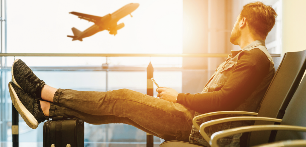 a-man-looking-at-a-plane-takeoff
